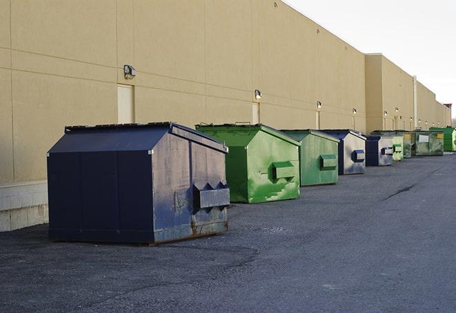 a group of construction workers taking a break near a dumpster in Alum Bank PA